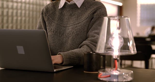 Person Working on Laptop in Modern Interior