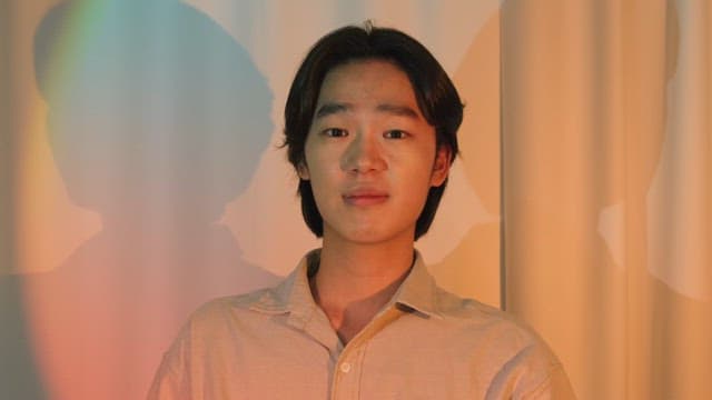 Young man smiling with colorful lights