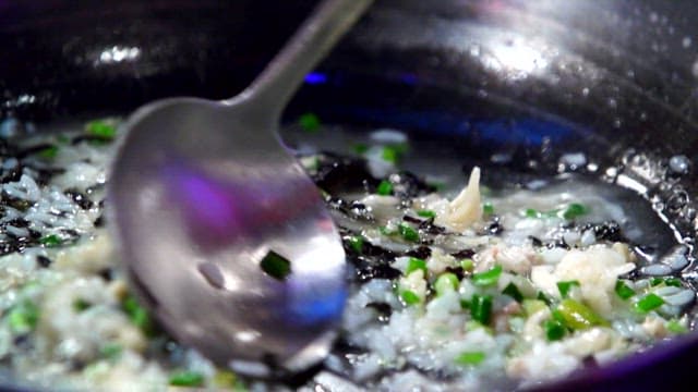 Korean porridge being stirred in a pot