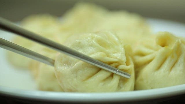 Close-Up of Dumplings with Chopsticks