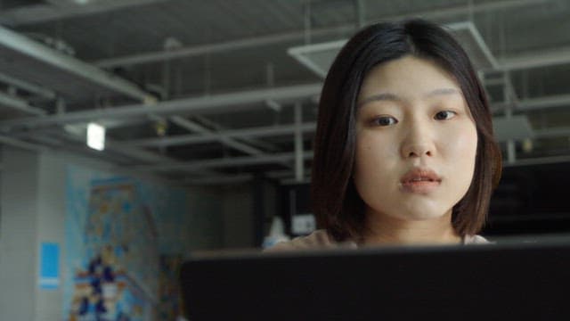 Woman working on a tablet indoors