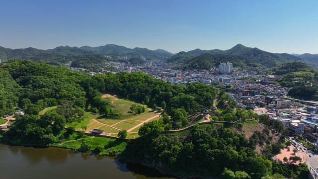 Beautiful city surrounded by lush green hills