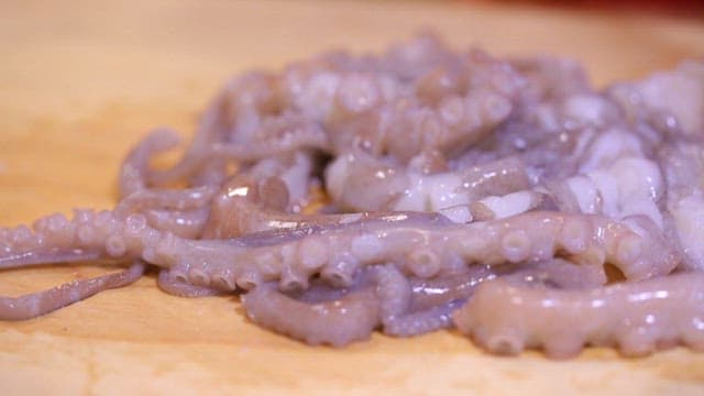 Chopping Octopus on a Wooden Cutting Board