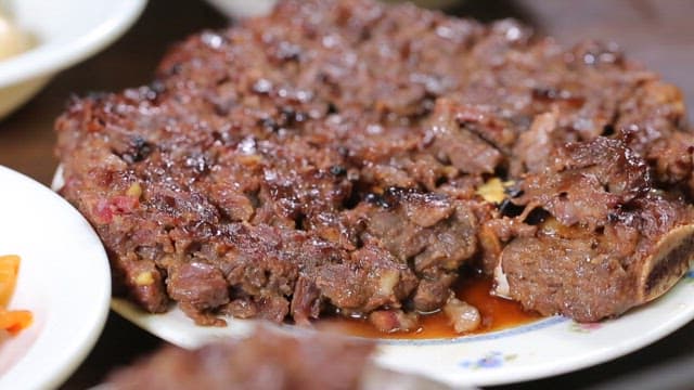 Spoonful of rice topped with juicy tteokgalbi