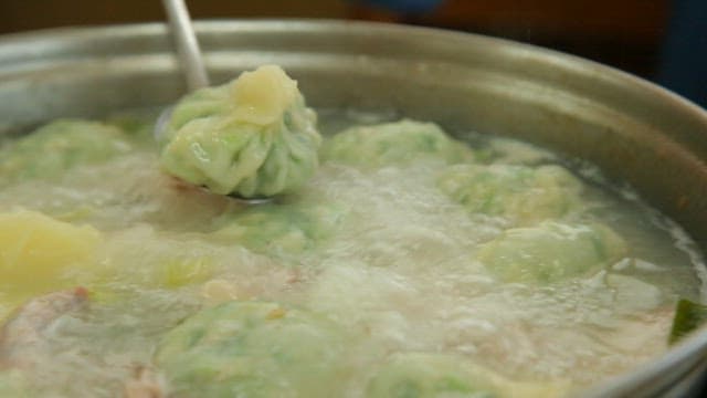 Dumplings boiling in a chicken soup