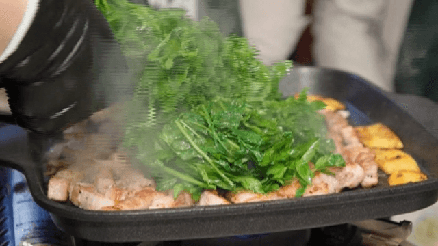 Cut water parsley on top of pork belly