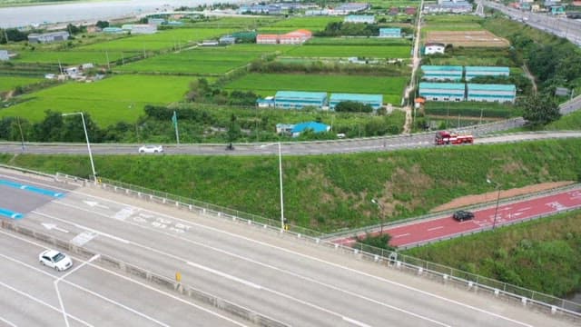 Vehicles moving along highways and toll booths by the riverside