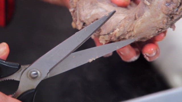 Cooked pork backbone trimmed with scissors