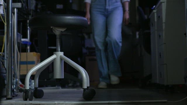 Woman sitting on a chair in a dimly lit office