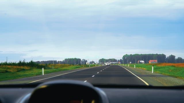 Driving on a scenic rural road with passing cars