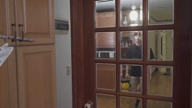 Man opening the door of a cozy house and entering