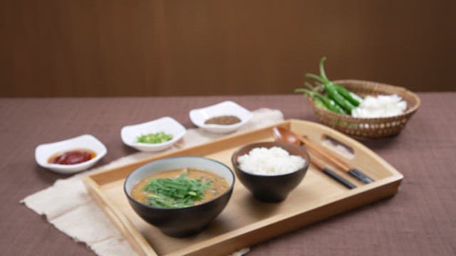 Neat Korean meal table with a bowl of hot chueotang and rice