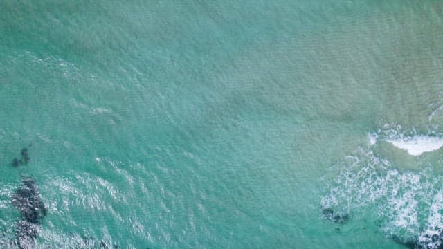 Serene Coastal Landscape with Wave of Emerald water