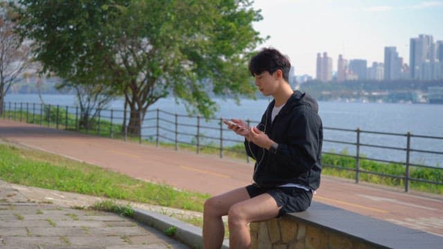 Man listening to music by the riverside