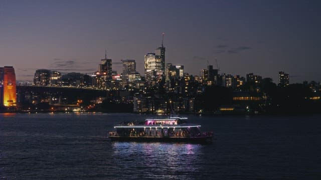 Cruise ship floating on the river at night with colorful lights