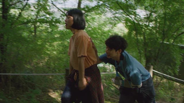 Couple climbing the stairs of a hiking trail in the forest