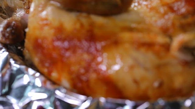 Juicy wood-fired chicken on foil