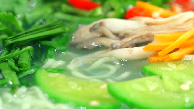 Adding marsh snails to soup with various vegetables