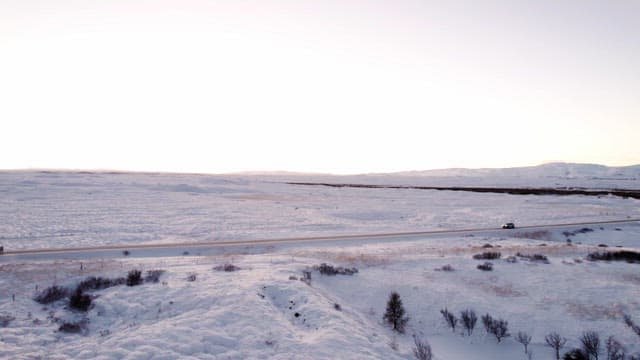Car driving through a snowy landscape