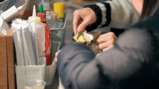 People enjoying fresh oysters with lemon