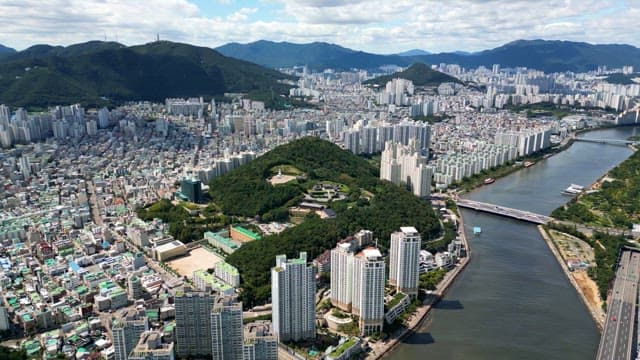 Sprawling city with a river and mountains