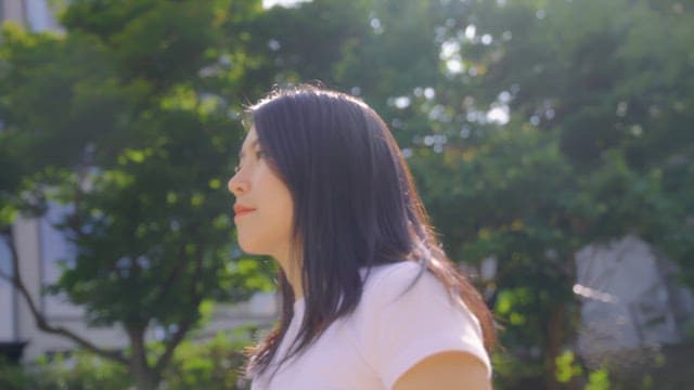 Woman smiling and waving outdoors