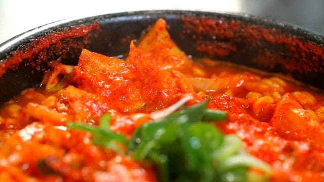 Spicy seafood ramyeon boiling in hot pot