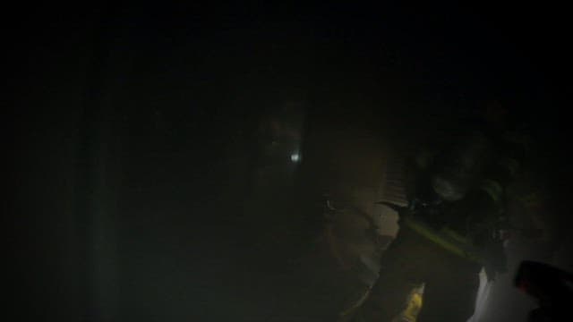 Firefighters Entering a Dark and Smoke-Filled Room