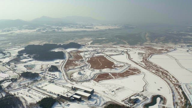 Snow-covered landscape with various terrain