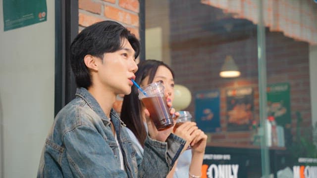 Couple enjoying iced coffee outdoors