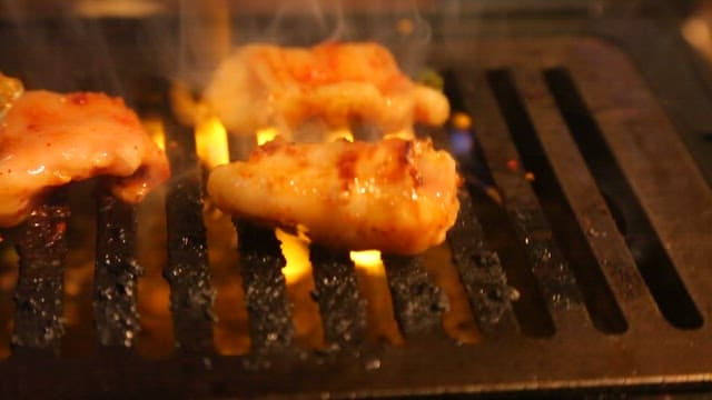 Sizzling marinated meat on a grill