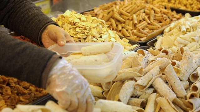 Market Merchant Putting Traditional Korean snacks in containers