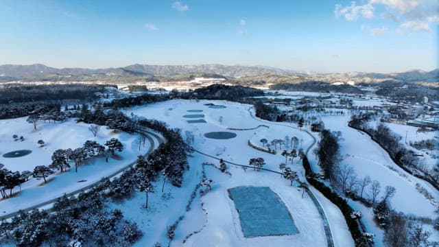 Snow-covered Landscape with Ponds and Roads