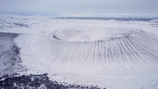 Snow-covered volcanic crater in winter