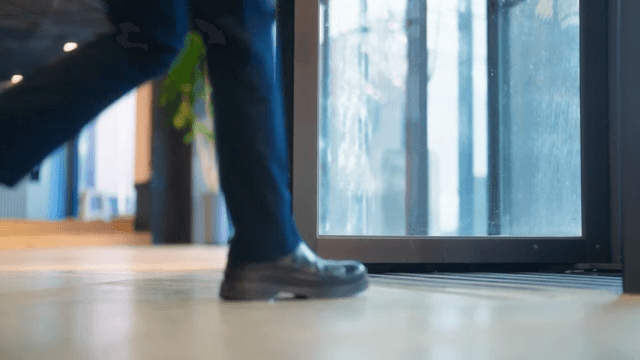Person exiting through revolving door