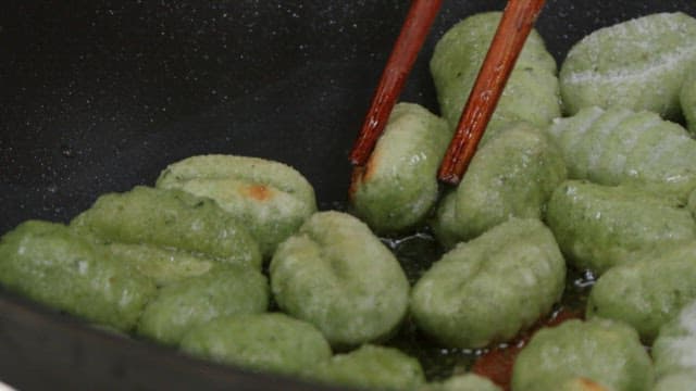 Gnocchi dough cooked on a heated frying pan