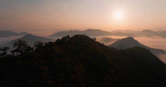 Sky Colored by Sunrise over Foggy Mountains