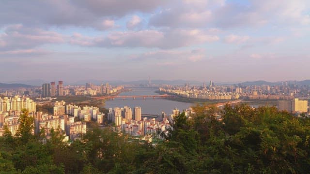 Cityscape with a river and bridges at sunset
