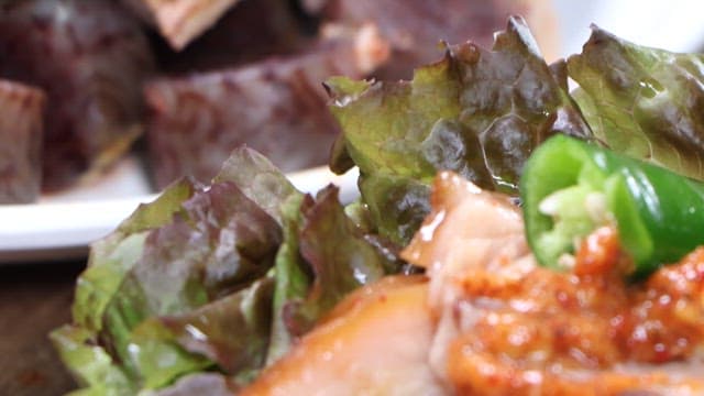 Piece of pig's feet dipped in salted shrimp and placed on lettuce
