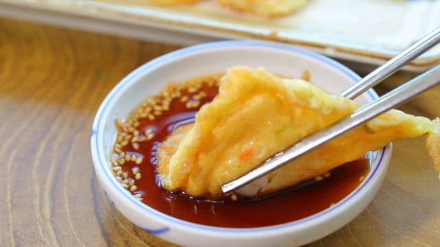 Pancake made of skate dipped in soy sauce
