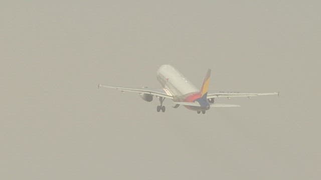 Airplane taking off in foggy conditions