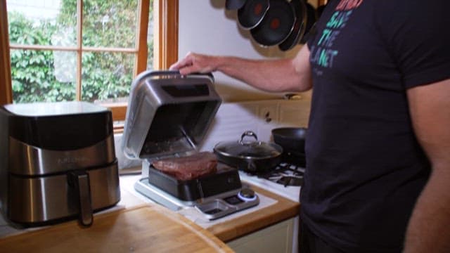 Man Preparing Meat in Home Kitchen