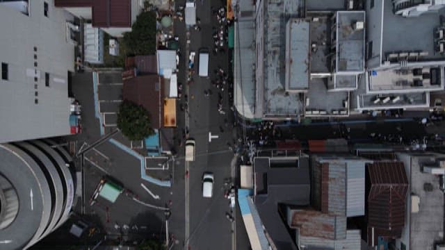 Bustling Urban Street with Vehicles and Pedestrians