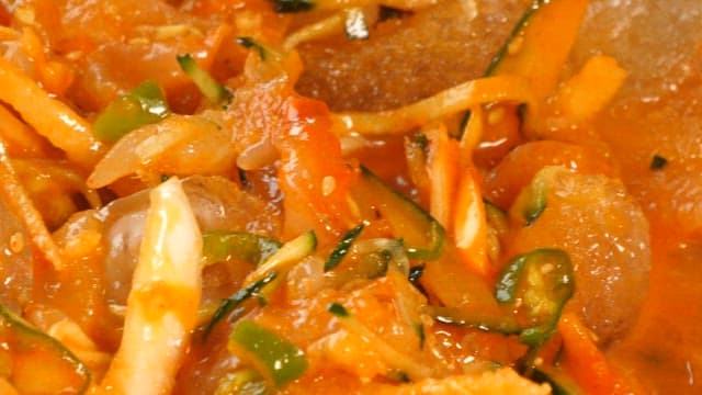 Chopstickful of cool raw fish soup mixed in a bowl