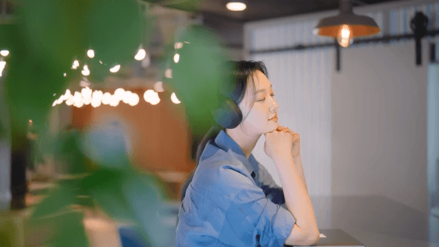 Woman enjoying music with headphones indoors