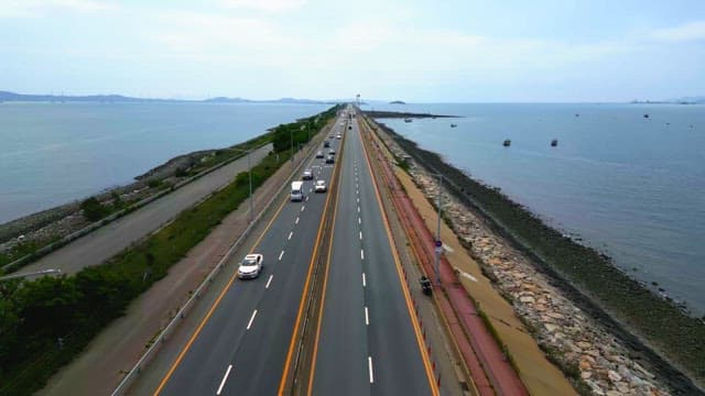 Coastal highway with cars and ocean view