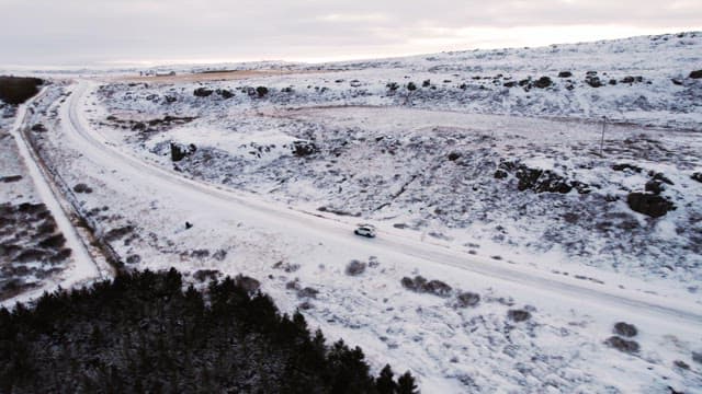 Car driving through a snowy landscape