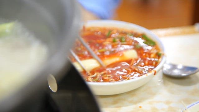 Rice cake dipped in spicy sauce