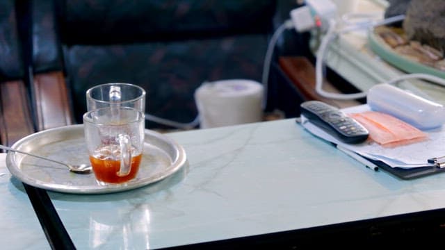 Glass of tea on a table with documents