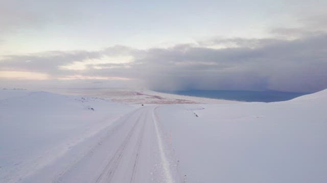 Snowy road stretching into the distance